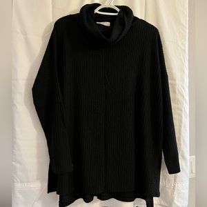 Black cowl-neck sweater.